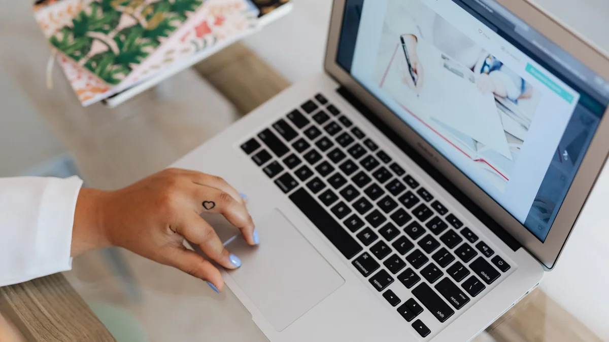 A person using a laptop at a desk, focusing on technology and efficiency, illustrating tivimate iphone